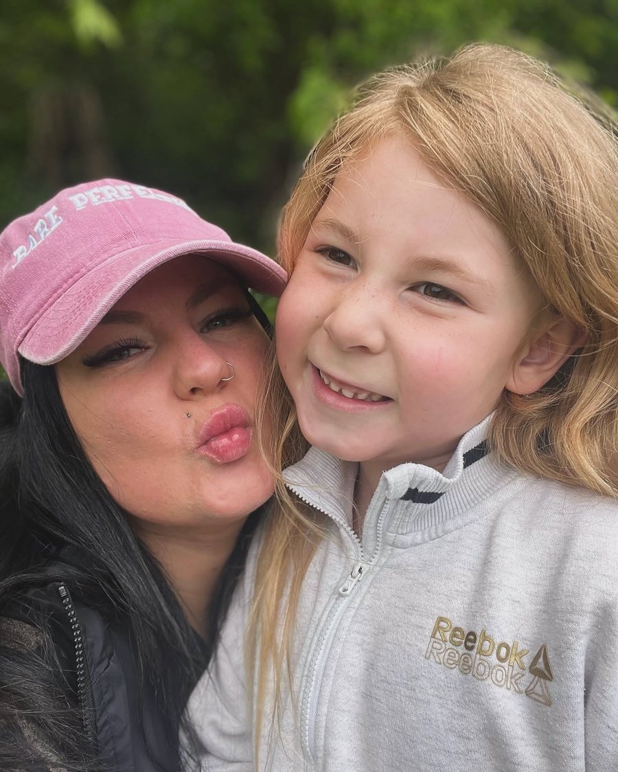 Brittney Pearce, owner of Bare Perfection, in a pink Bare Perfection cap, smiling cheek to cheek with her daughter